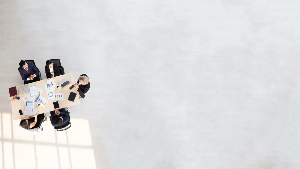 Overhead view of a team meeting around a conference table